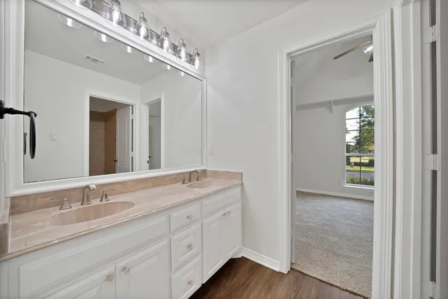 a bathroom with a double vanity sink and a mirror