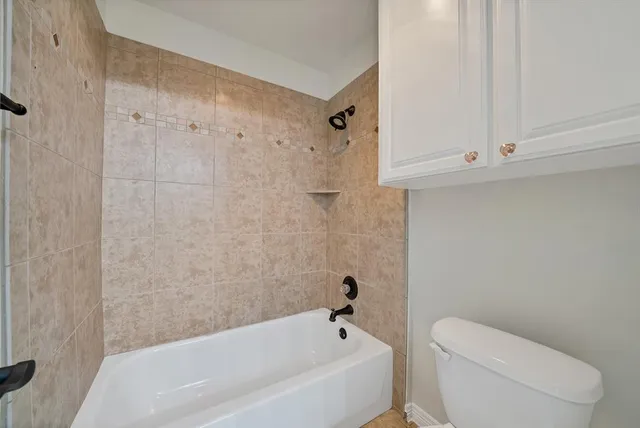 a bathroom with a bathtub and a toilet