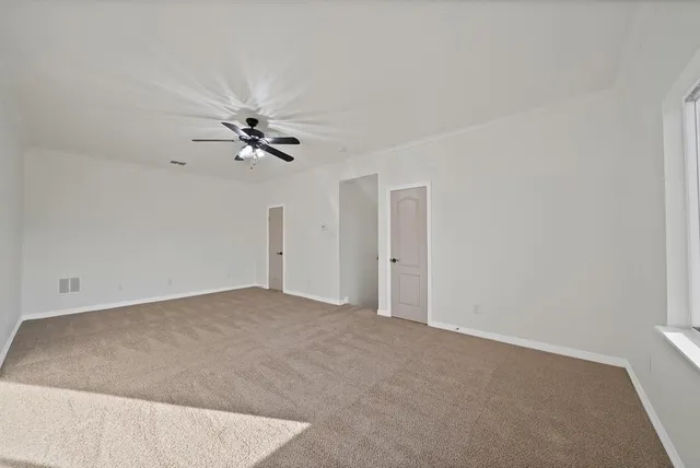 a view of a big room with ceiling fan