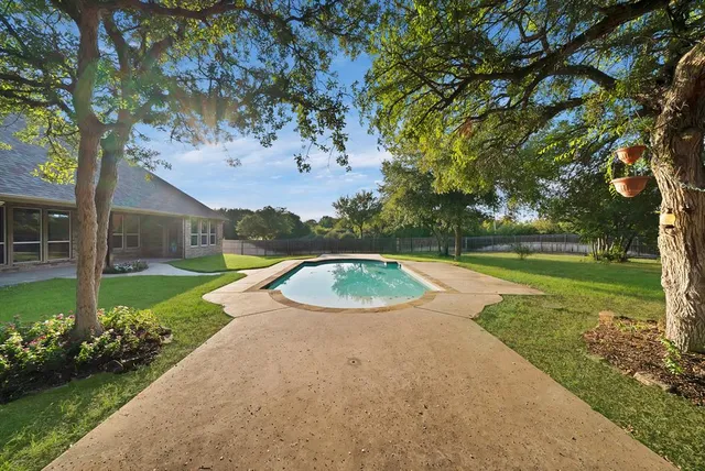 a view of a swimming pool with a garden