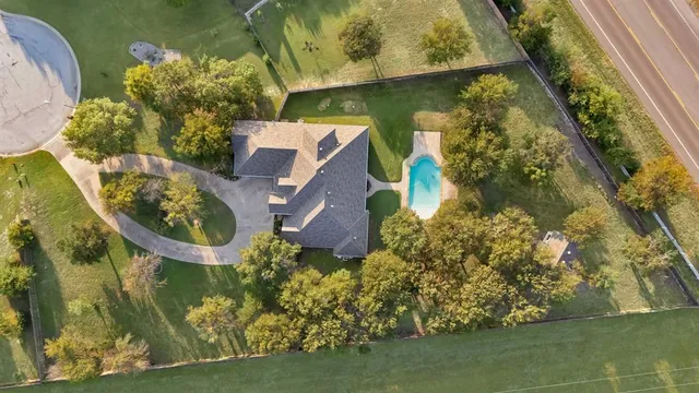 an aerial view of a house with a yard basket ball court and outdoor seating