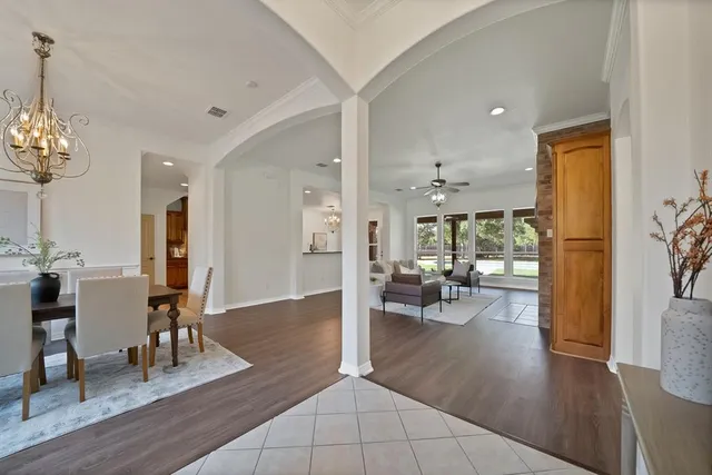 a view of a livingroom with furniture wooden floor and a chandelier