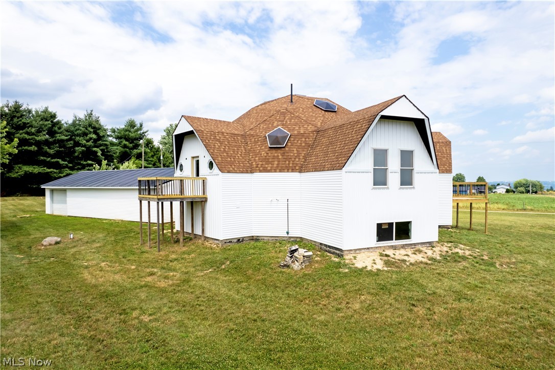 View of property exterior featuring a lawn