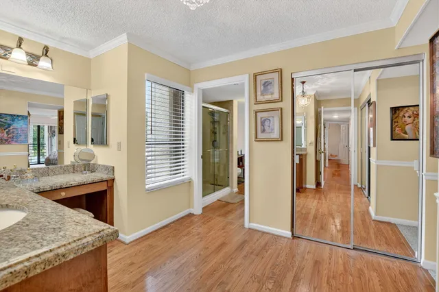 front view of a house with a yard and potted plants