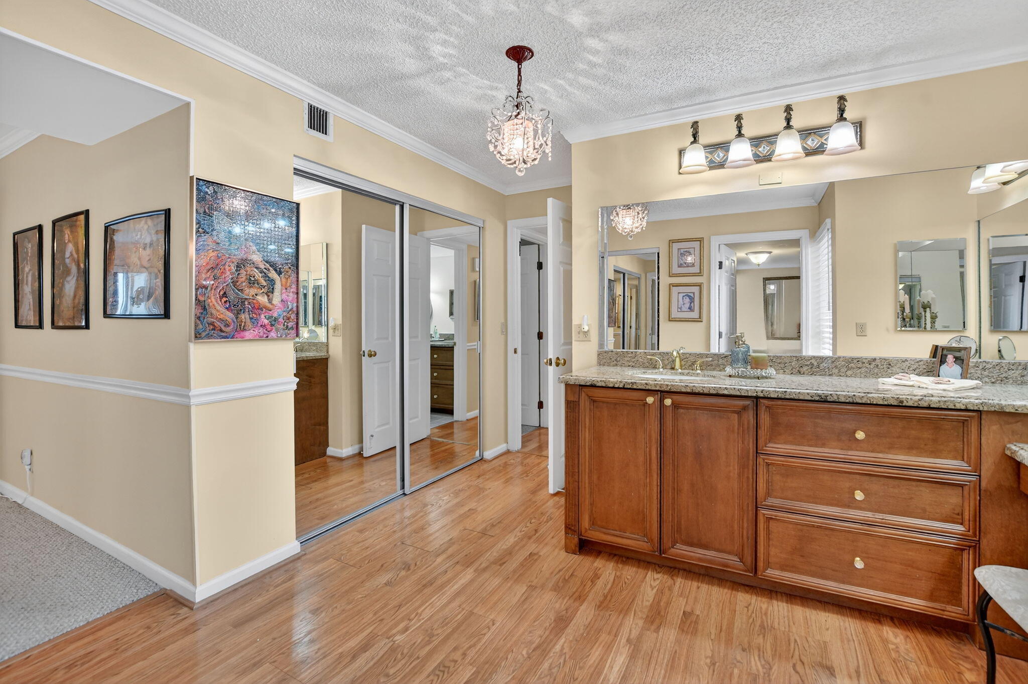 5650 Camino Del Sol, Unit 200 Boca Raton, FL 33433 - Photo 17 of 38 a spacious en suite bathroom with a granite countertop sink mirror and cabinets