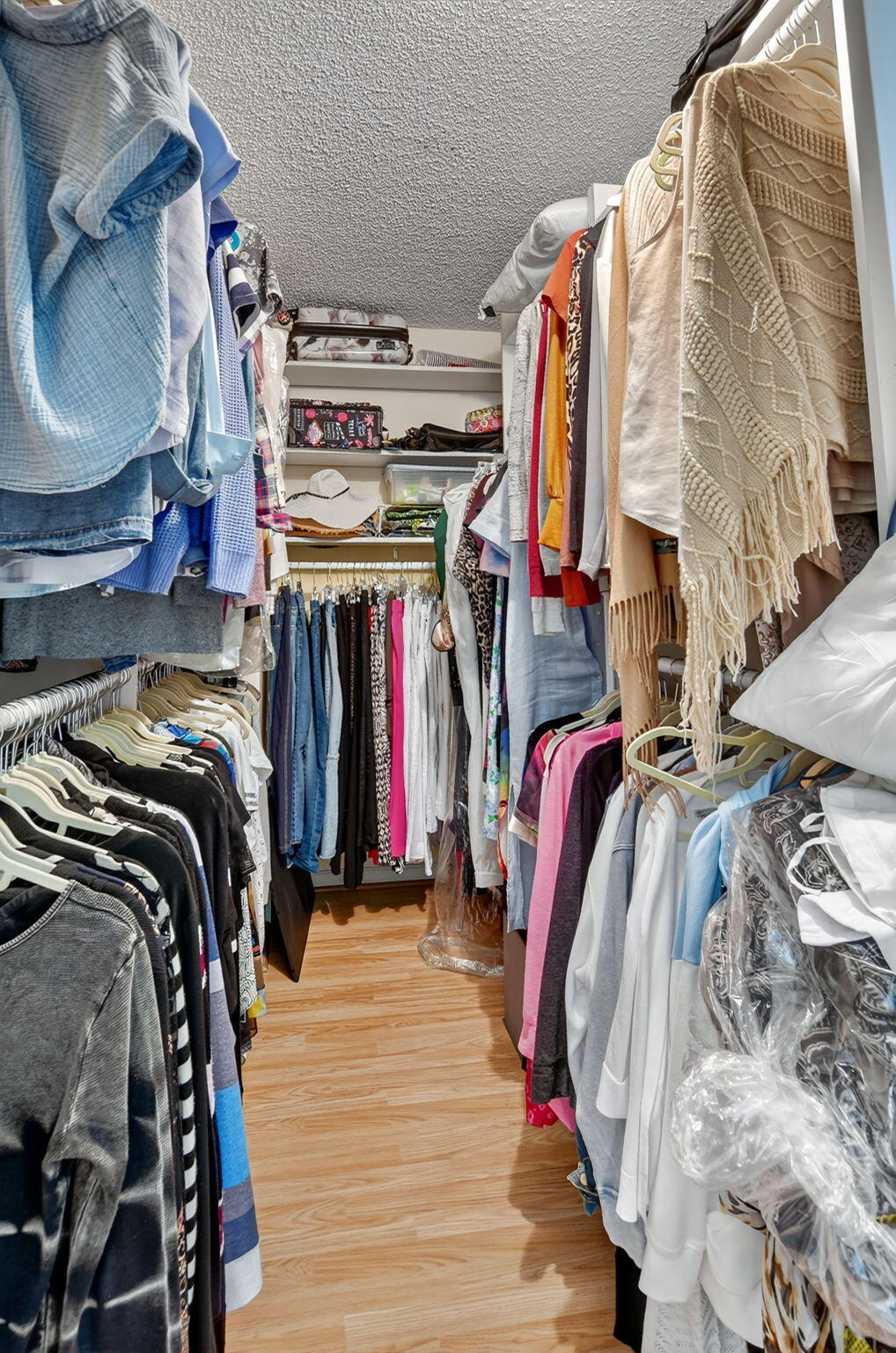 5650 Camino Del Sol, Unit 200 Boca Raton, FL 33433 - Photo 20 of 38 a view of walk in closet with clothes and shoes