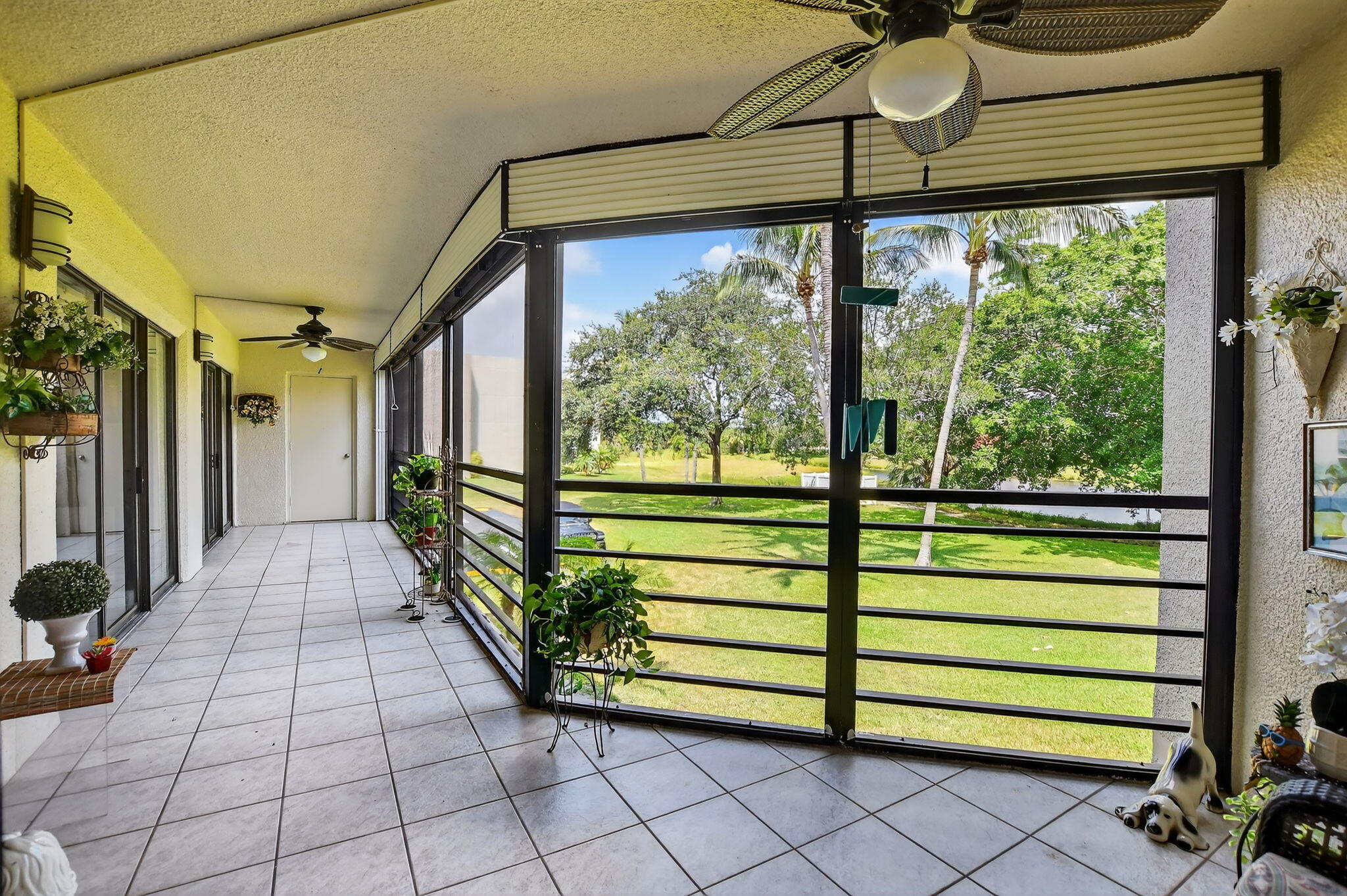5650 Camino Del Sol, Unit 200 Boca Raton, FL 33433 - Photo 29 of 38 a view of a porch with wooden floor