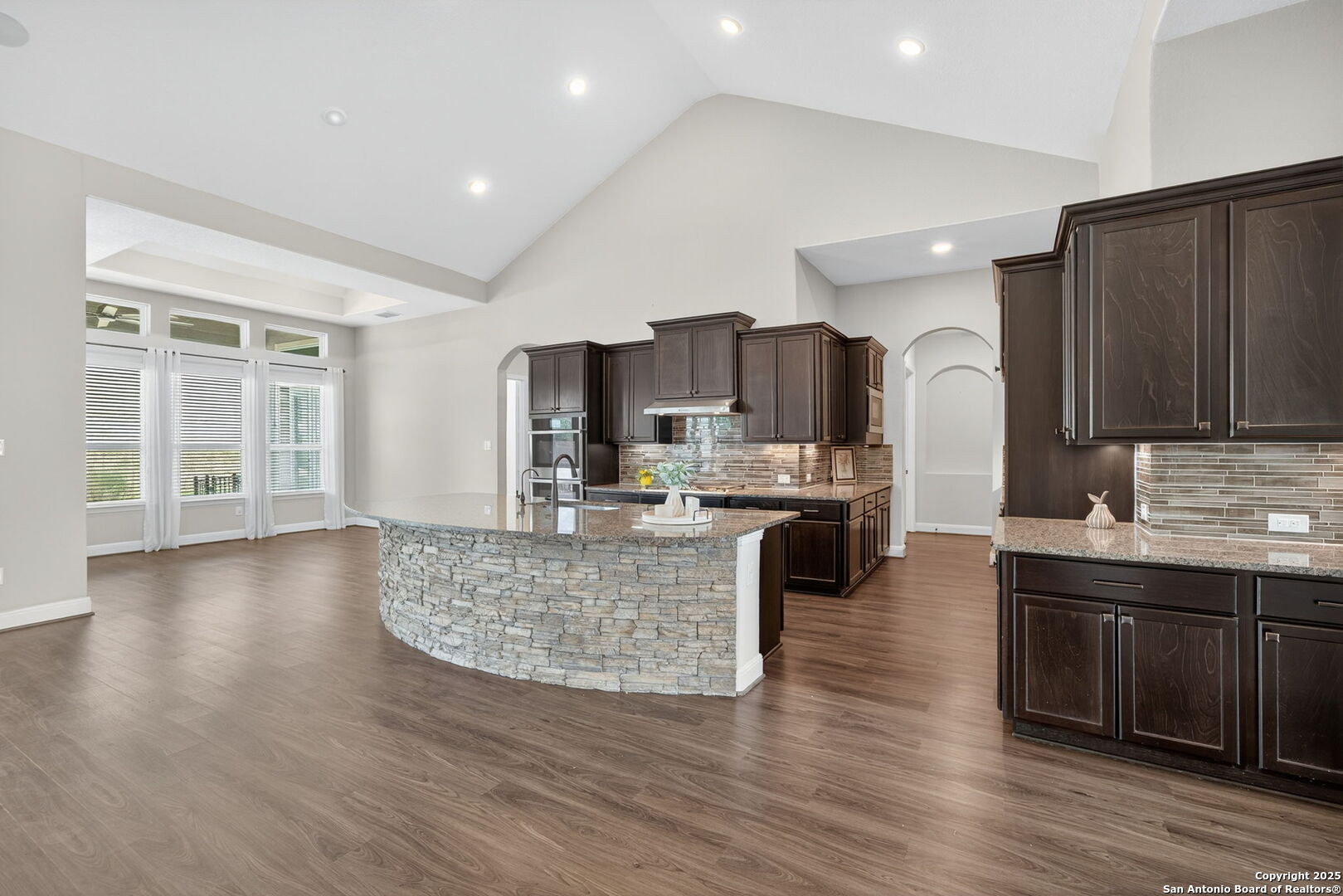 8283 Apache Forest Garden Ridge, TX 78266 - Photo 12 of 42 a large kitchen with stainless steel appliances granite countertop a large center island attached withe living room
