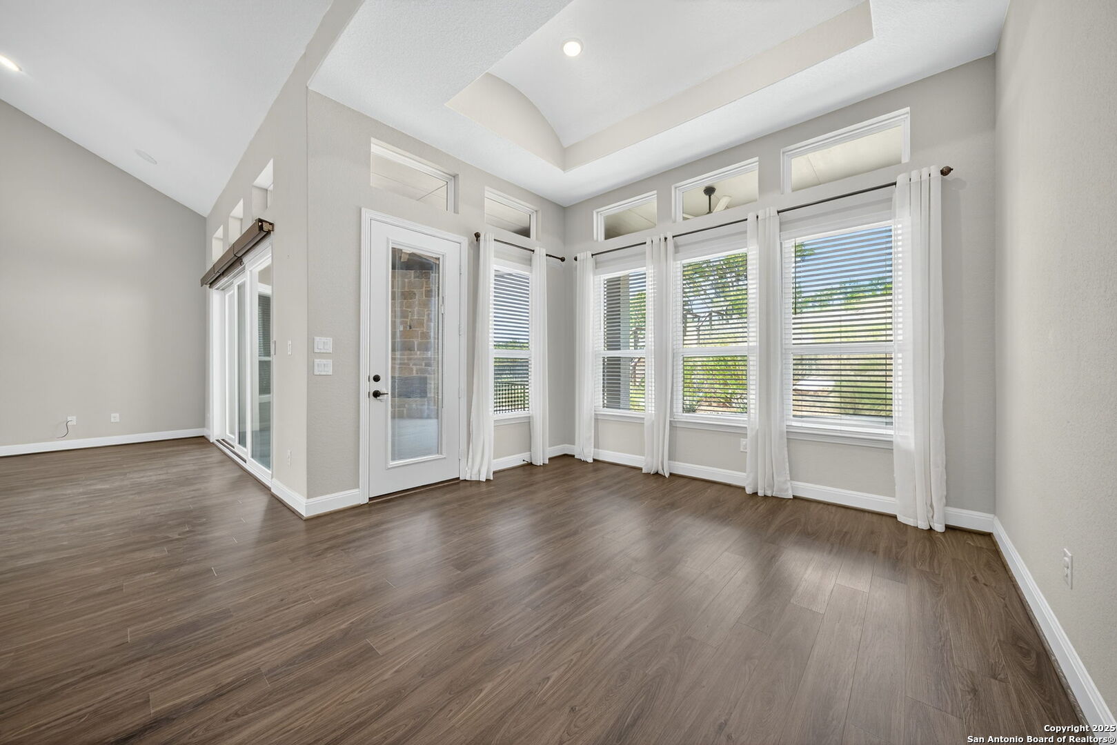 8283 Apache Forest Garden Ridge, TX 78266 - Photo 15 of 42 a view of an empty room with wooden floor and a window