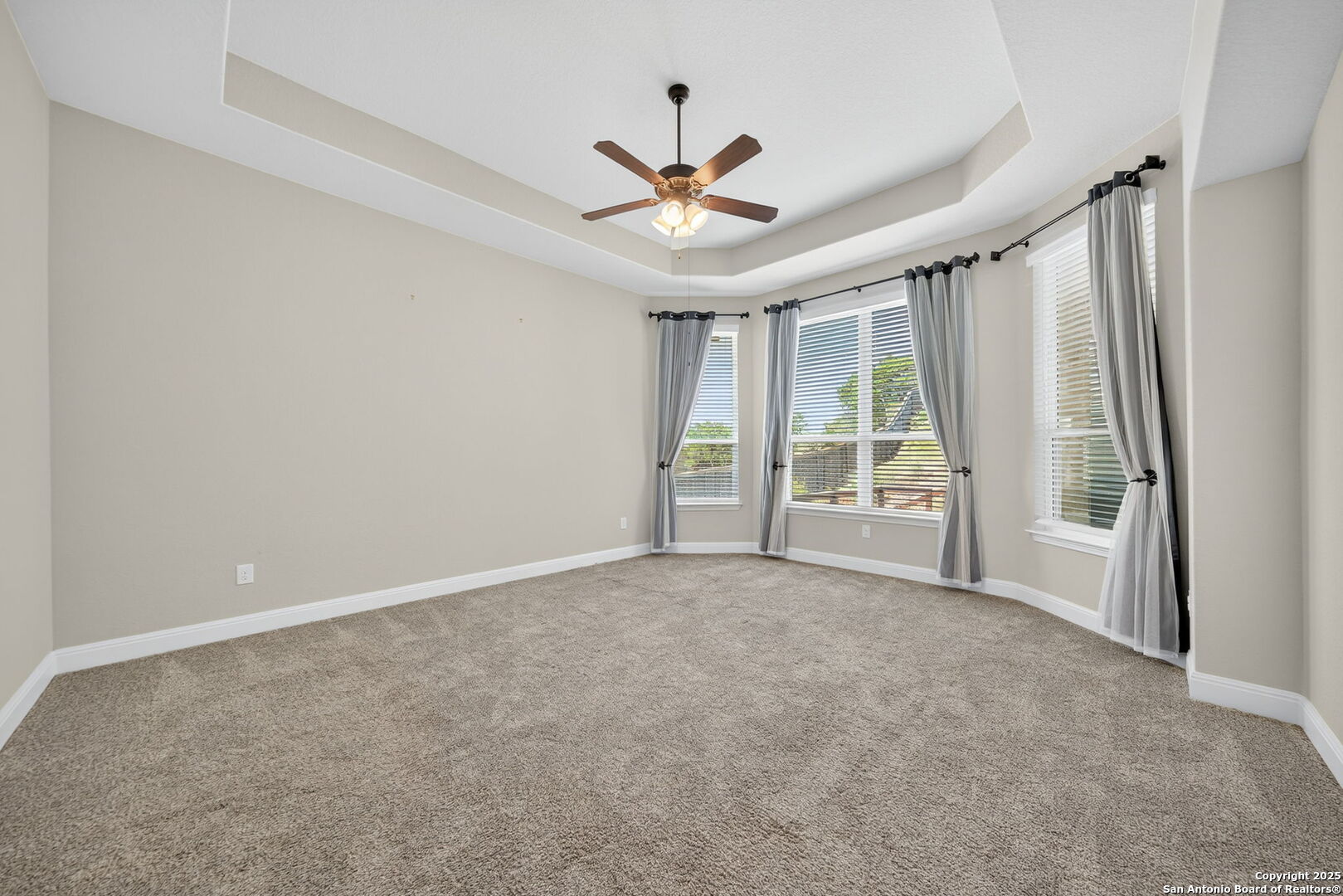 8283 Apache Forest Garden Ridge, TX 78266 - Photo 21 of 42 an empty room with windows and ceiling fan