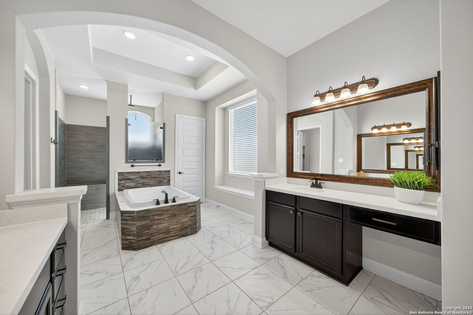 8283 Apache Forest Garden Ridge, TX 78266 - Photo 22 of 42 a large bathroom with a large tub and sink