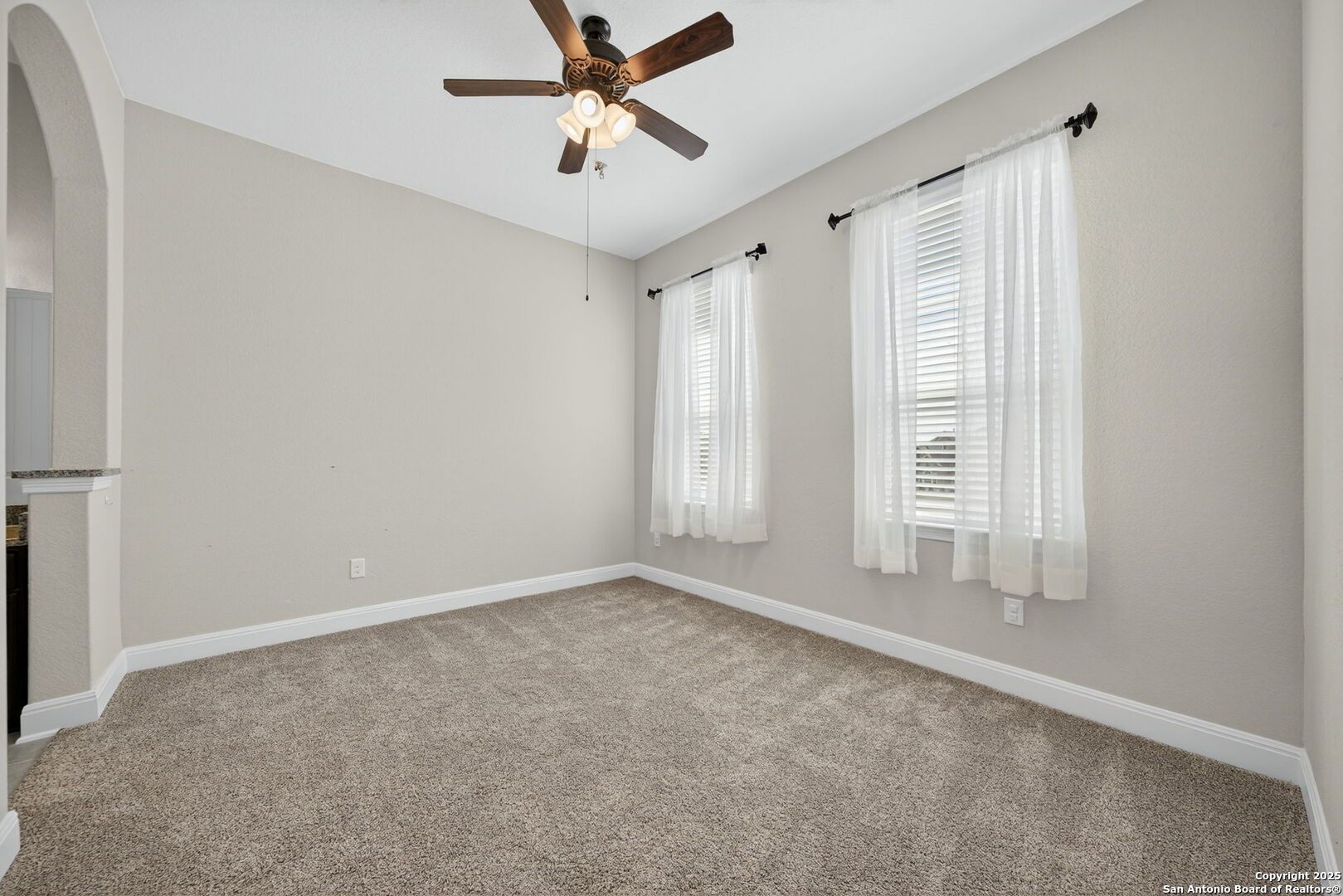8283 Apache Forest Garden Ridge, TX 78266 - Photo 26 of 42 an empty room with windows and fan