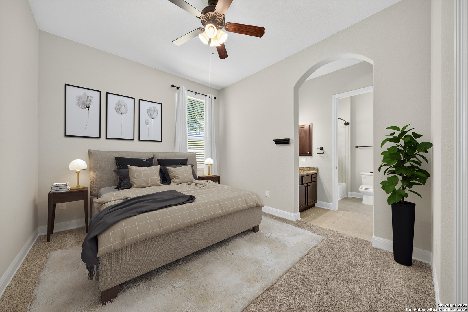 8283 Apache Forest Garden Ridge, TX 78266 - Photo 29 of 42 a spacious bedroom with a bed and a chandelier