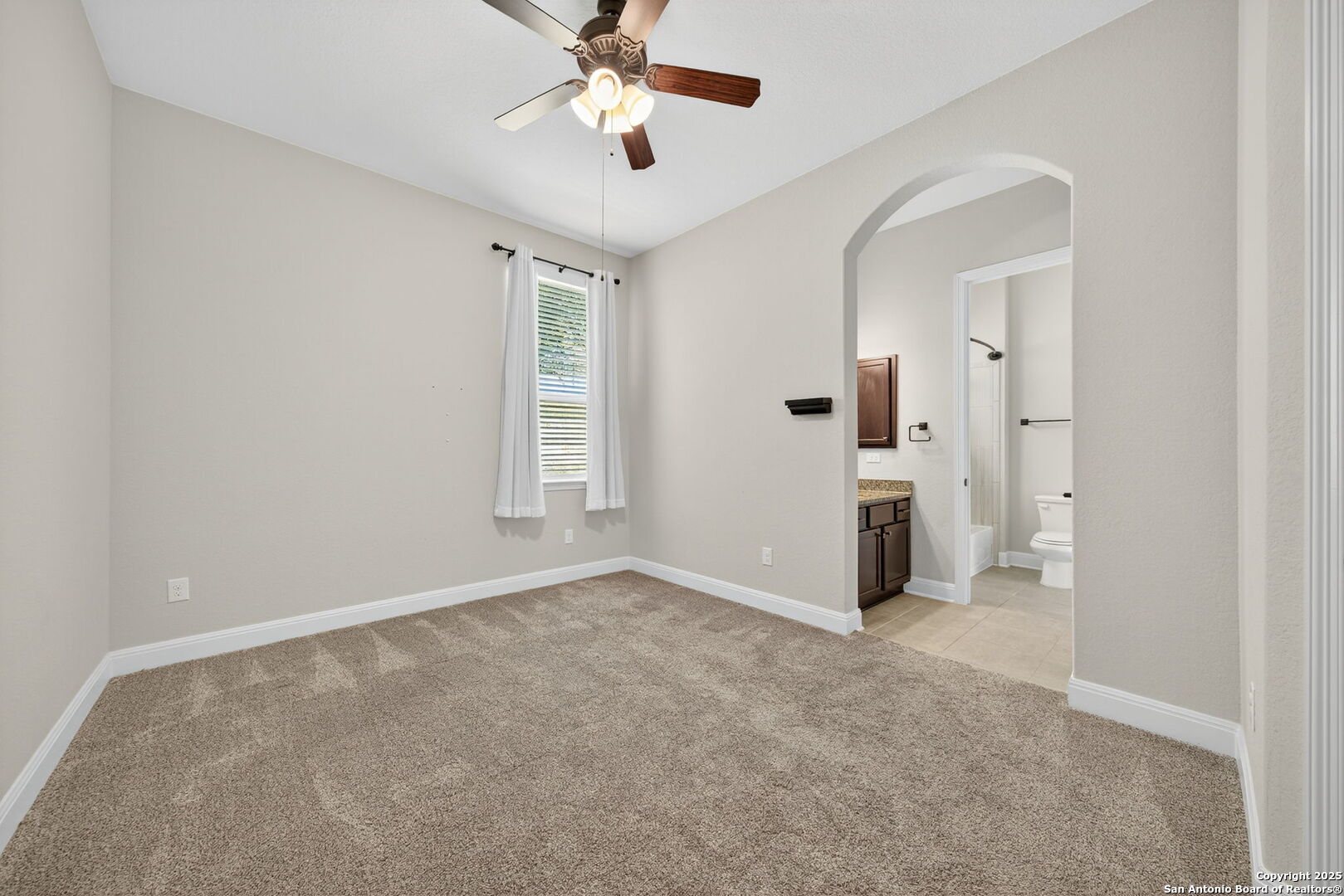 8283 Apache Forest Garden Ridge, TX 78266 - Photo 30 of 42 an empty room with chandelier fan and windows