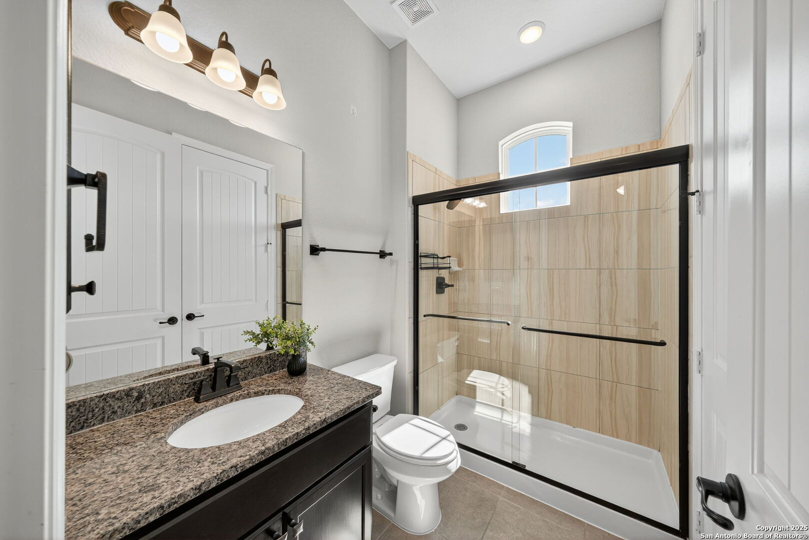 8283 Apache Forest Garden Ridge, TX 78266 - Photo 32 of 42 a bathroom with a granite countertop sink toilet and shower