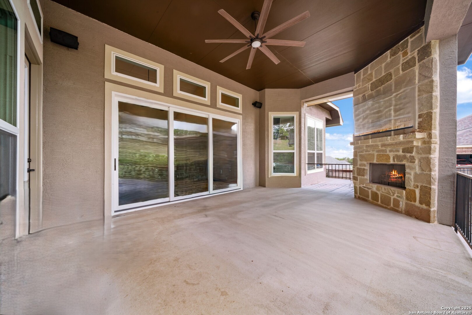 8283 Apache Forest Garden Ridge, TX 78266 - Photo 33 of 42 a view of an empty room with a fireplace and a window
