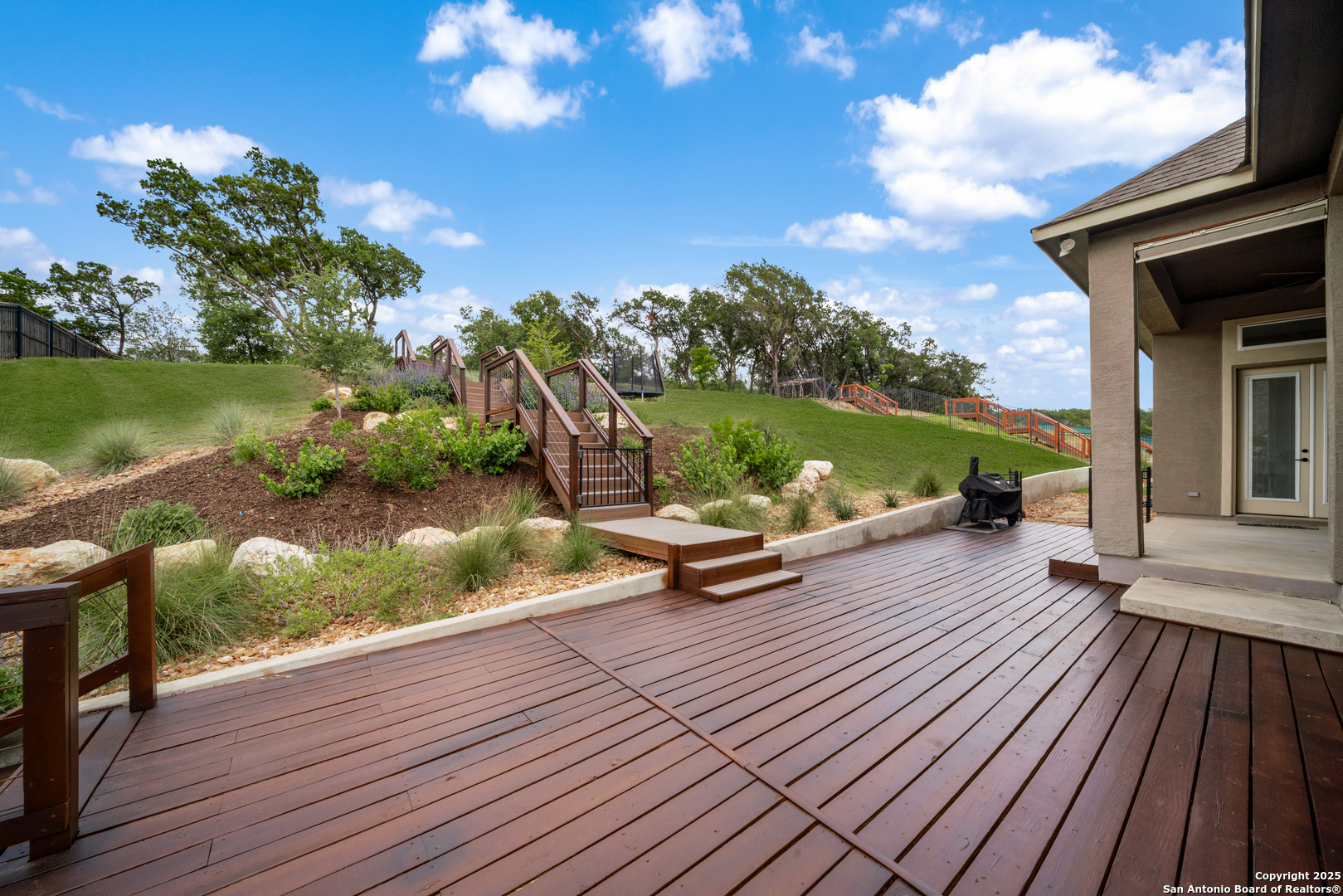 8283 Apache Forest Garden Ridge, TX 78266 - Photo 36 of 42 a view of a wooden deck with a yard