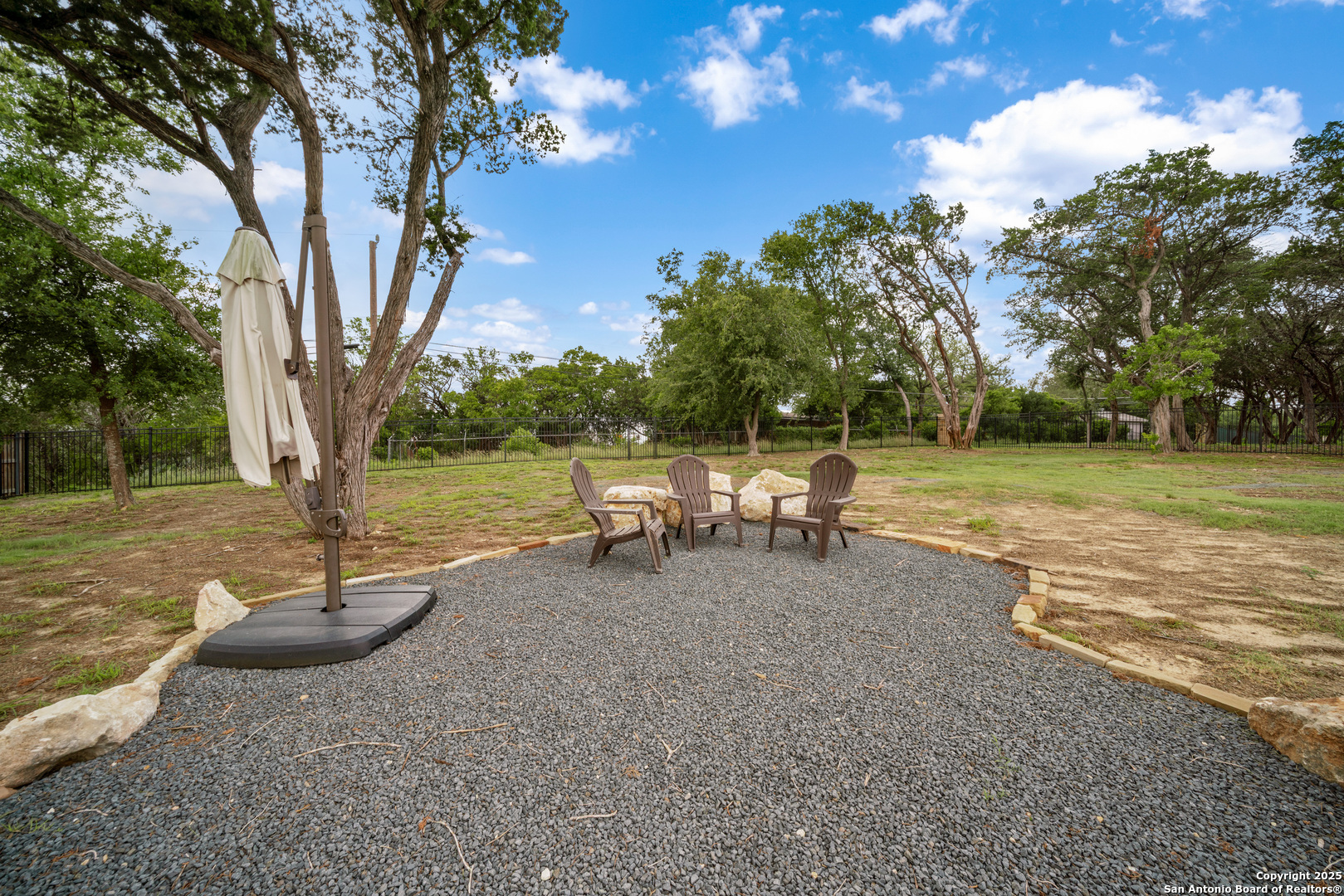 8283 Apache Forest Garden Ridge, TX 78266 - Photo 39 of 42 a backyard of a house with table and chairs