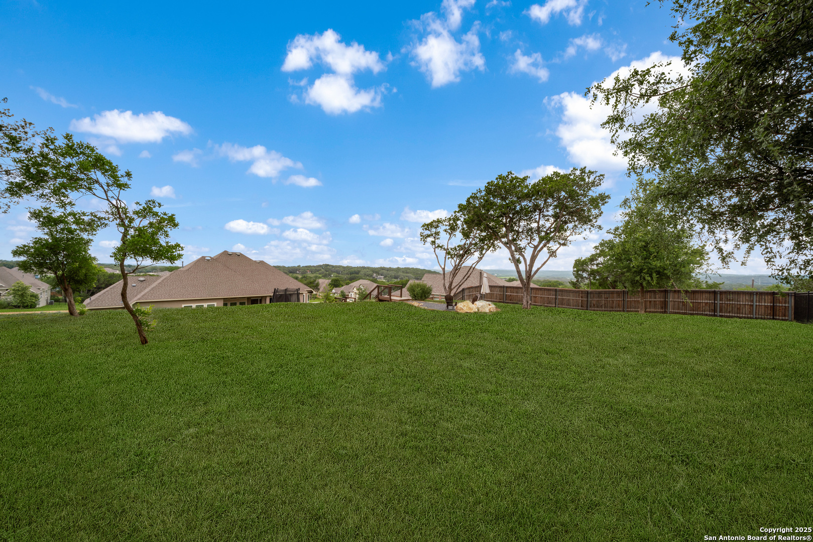 8283 Apache Forest Garden Ridge, TX 78266 - Photo 40 of 42 a view of a big yard with a large tree