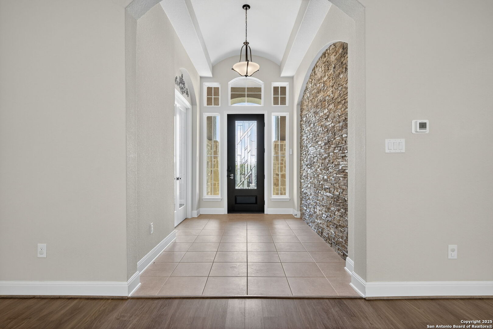 8283 Apache Forest Garden Ridge, TX 78266 - Photo 4 of 42 a view of a hallway with windows and chandelier