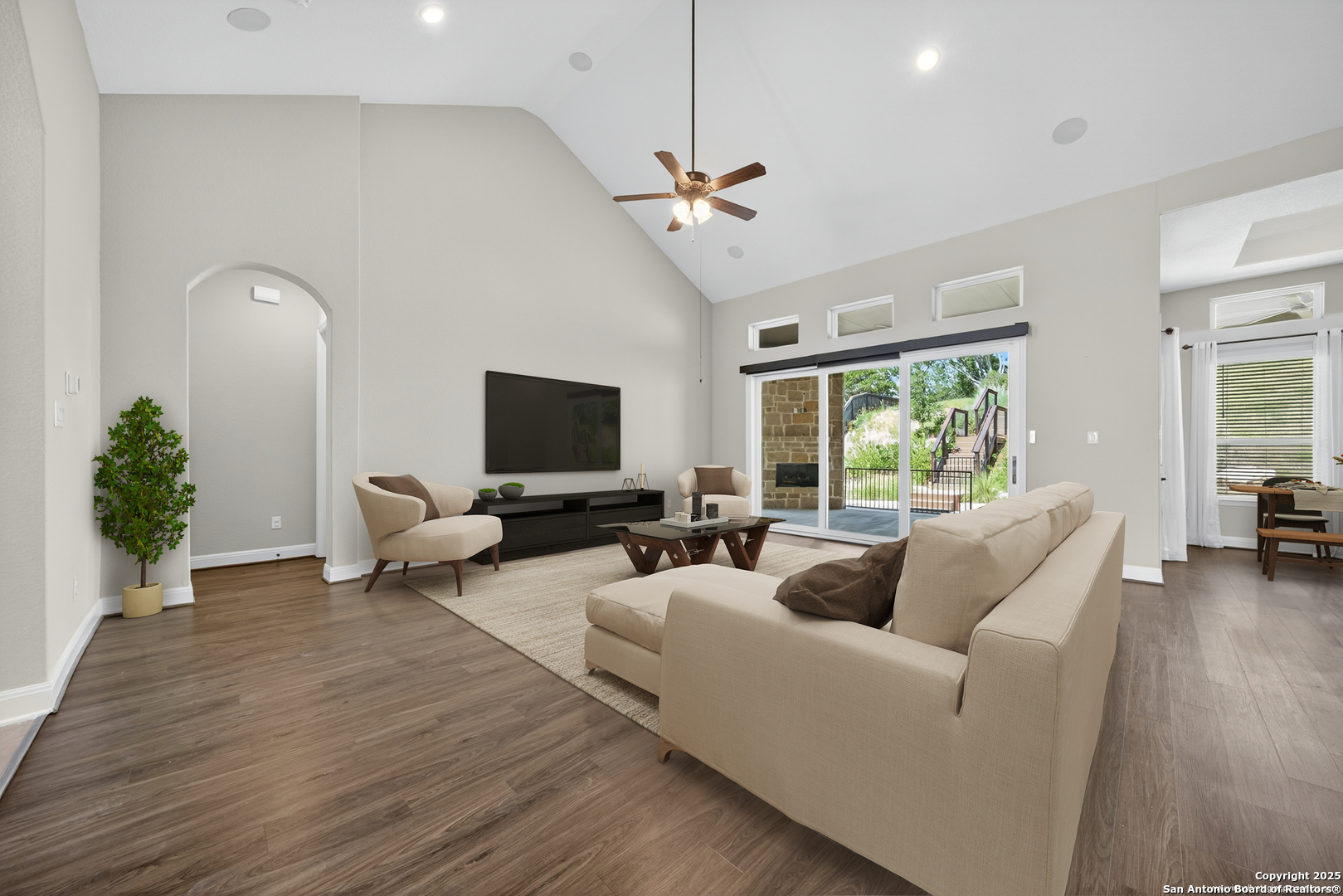8283 Apache Forest Garden Ridge, TX 78266 - Photo 5 of 42 a living room with furniture a ceiling fan and a flat screen tv