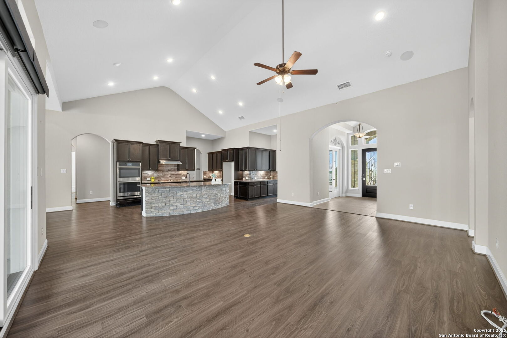8283 Apache Forest Garden Ridge, TX 78266 - Photo 9 of 42 a view of an empty room and kitchen with wooden floor