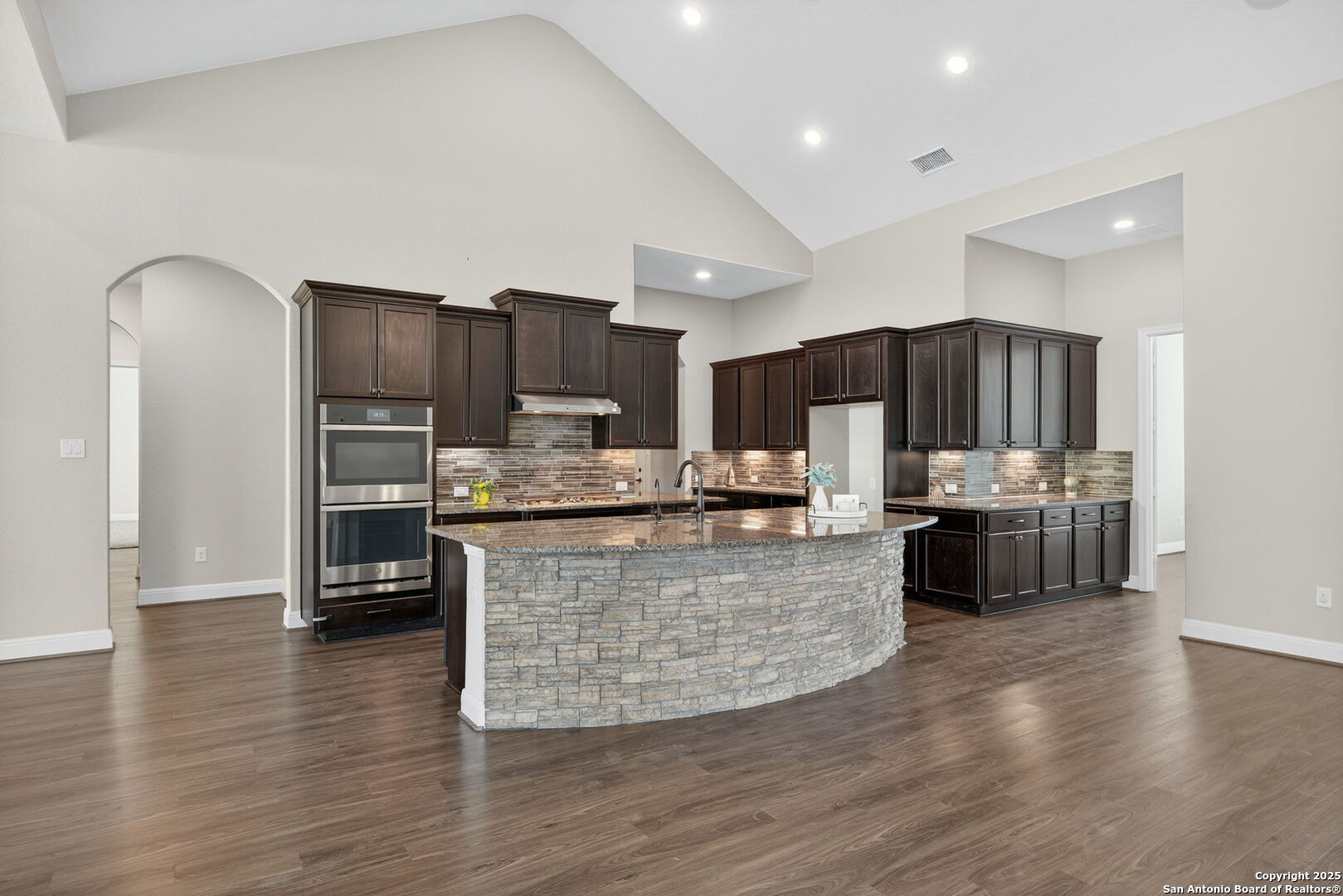 8283 Apache Forest Garden Ridge, TX 78266 - Photo 10 of 42 a kitchen with stainless steel appliances a refrigerator sink and wooden cabinets