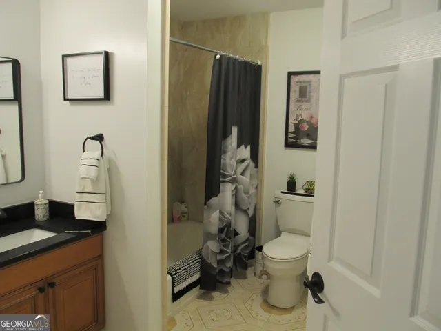 a bedroom with a bed and a dresser in it