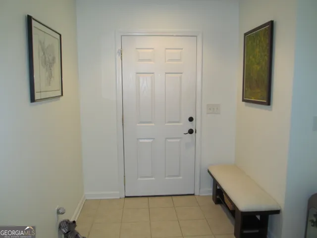 a living room with furniture a clock and a fireplace
