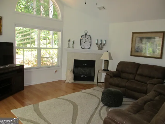 a bathroom with a granite countertop sink a mirror and shower