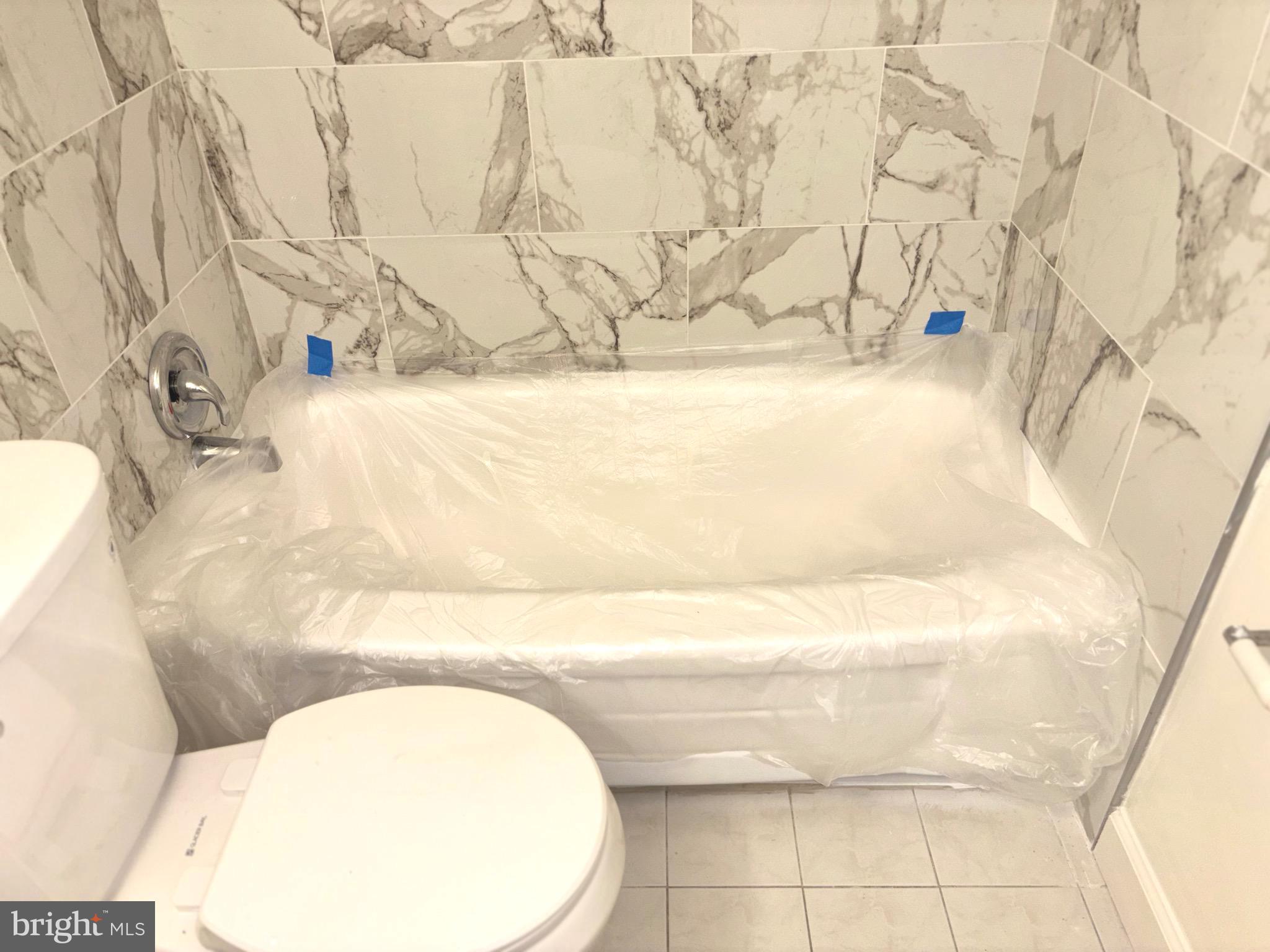 1832 Metzerott Road, Unit 105 Hyattsville, MD 20783 - Photo 12 of 16 a bathroom with a bathtub and shower