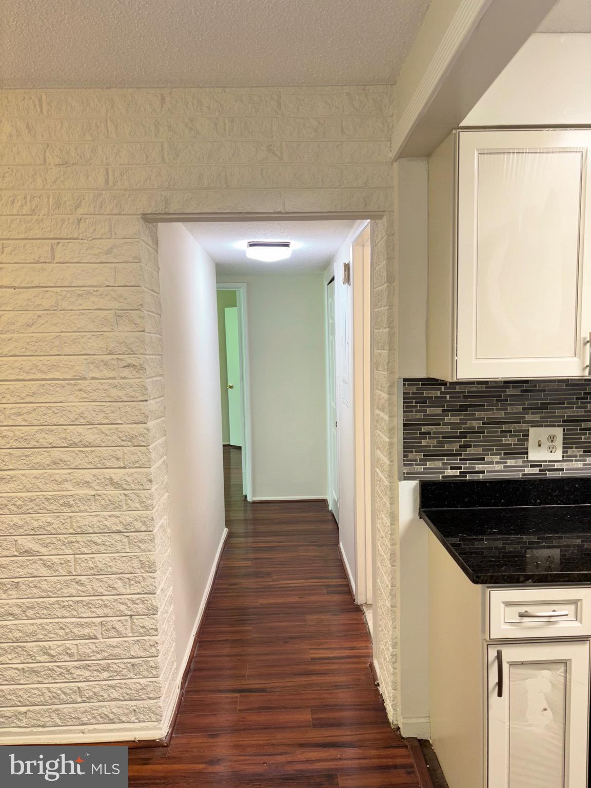 1832 Metzerott Road, Unit 105 Hyattsville, MD 20783 - Photo 8 of 16 a view of a hallway with wooden floor and staircase