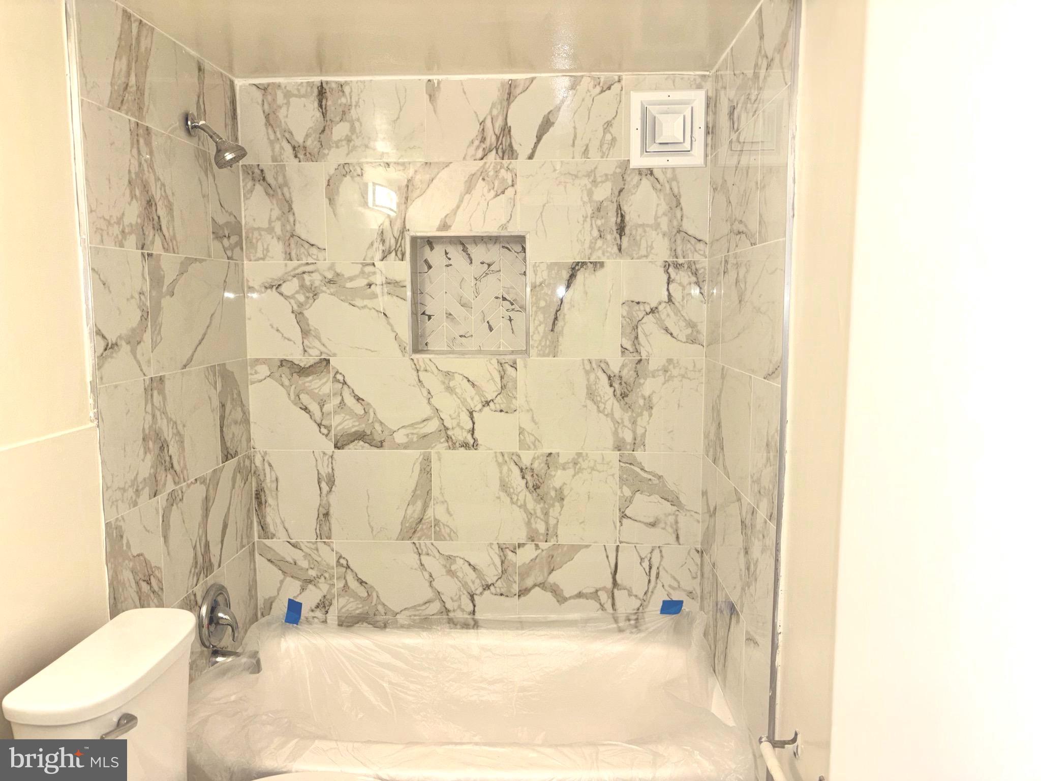 1832 Metzerott Road, Unit 105 Hyattsville, MD 20783 - Photo 9 of 16 a bathroom with a bathtub and shower