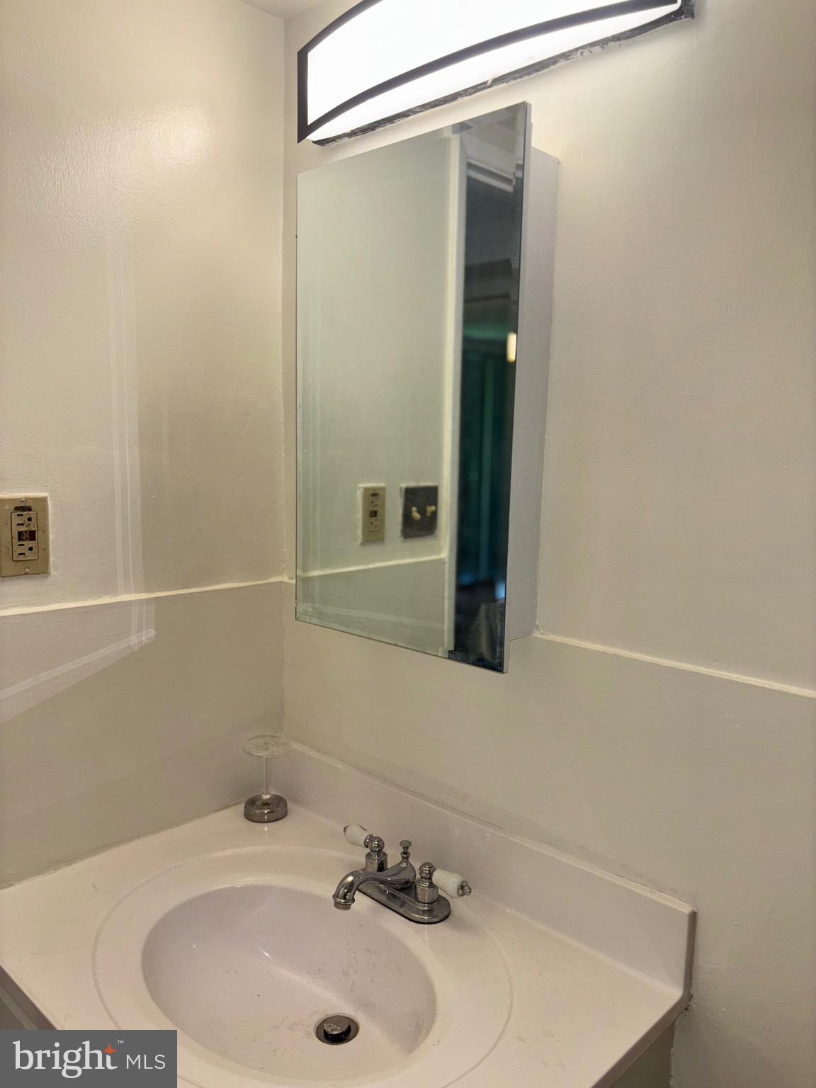 1832 Metzerott Road, Unit 105 Hyattsville, MD 20783 - Photo 10 of 16 a bathroom with a sink and a mirror