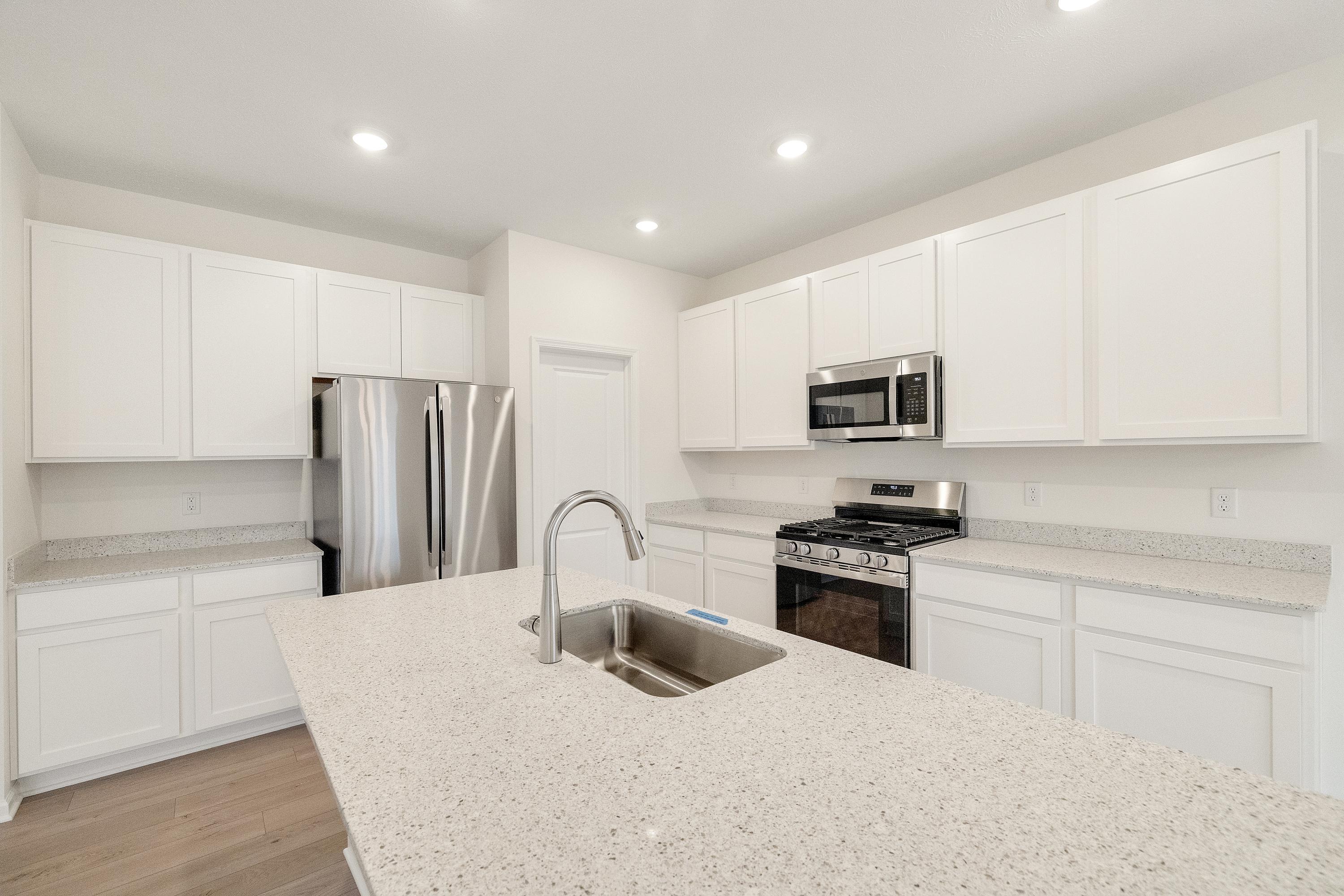 5264 Red Rock Lane Schererville, IN 46375 - Photo 2 of 21 a kitchen with stainless steel appliances granite countertop a refrigerator sink and white cabinets