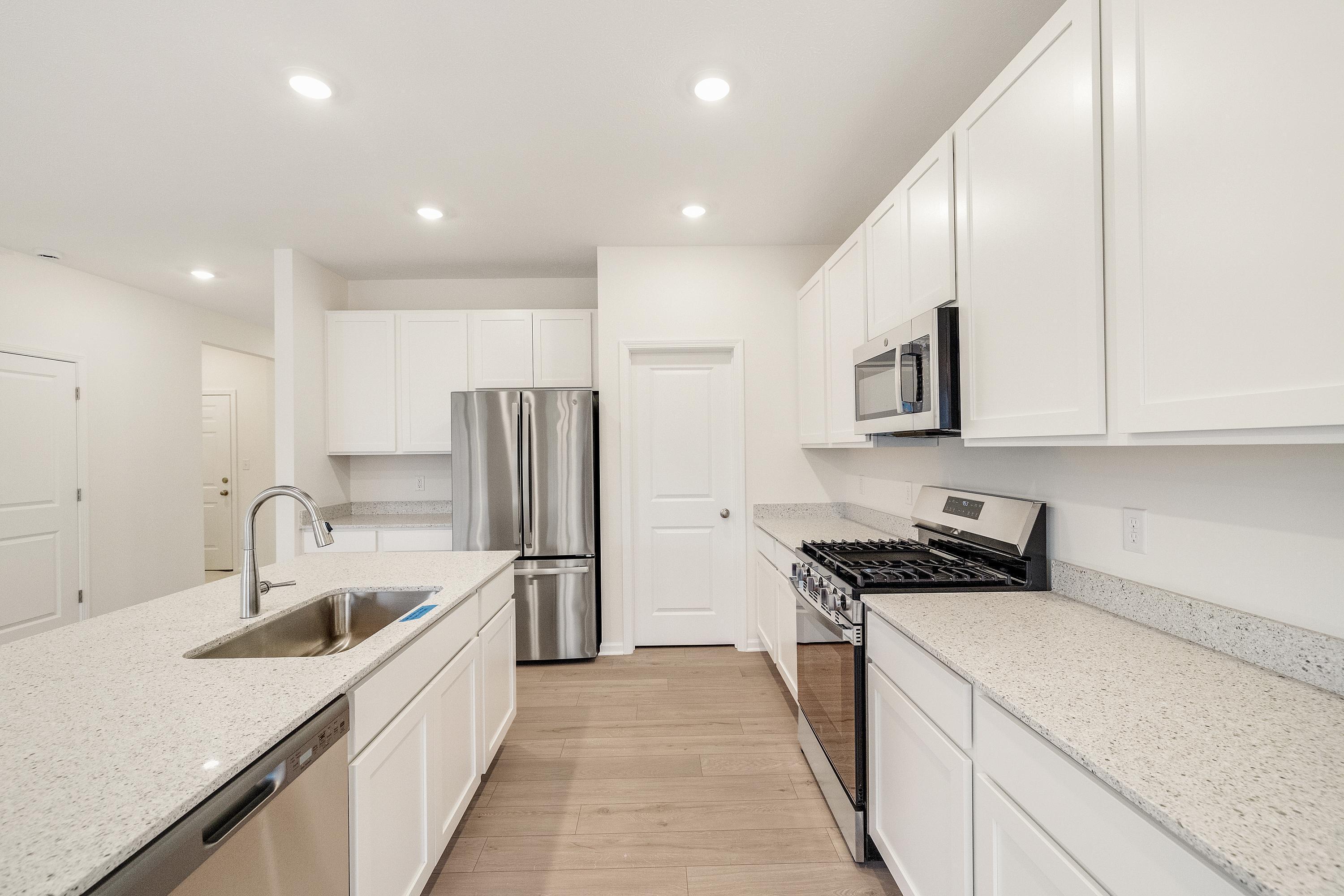 5264 Red Rock Lane Schererville, IN 46375 - Photo 4 of 21 a kitchen with stainless steel appliances granite countertop a sink stove and refrigerator