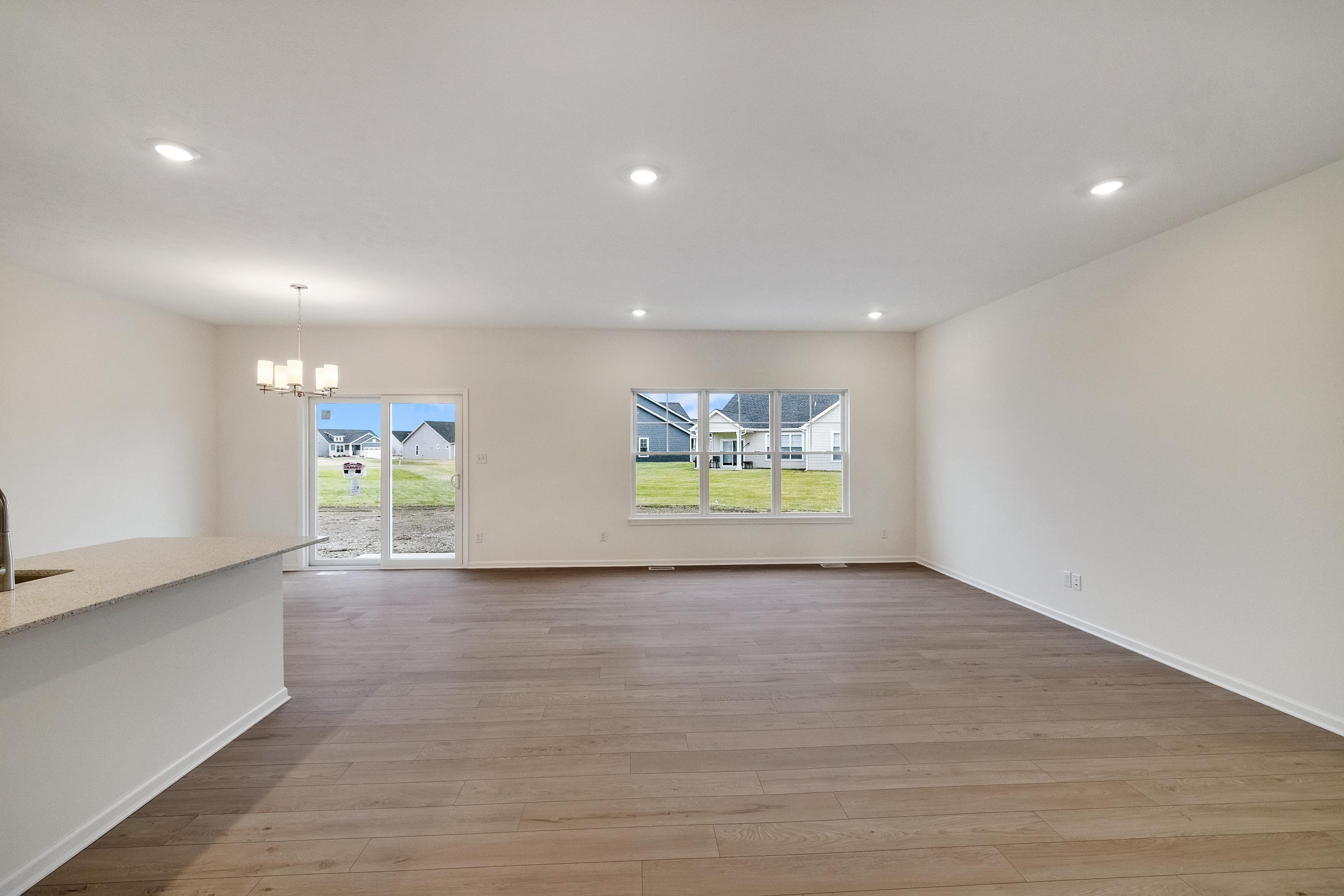 5264 Red Rock Lane Schererville, IN 46375 - Photo 6 of 21 a view of an empty room with a window and wooden floor