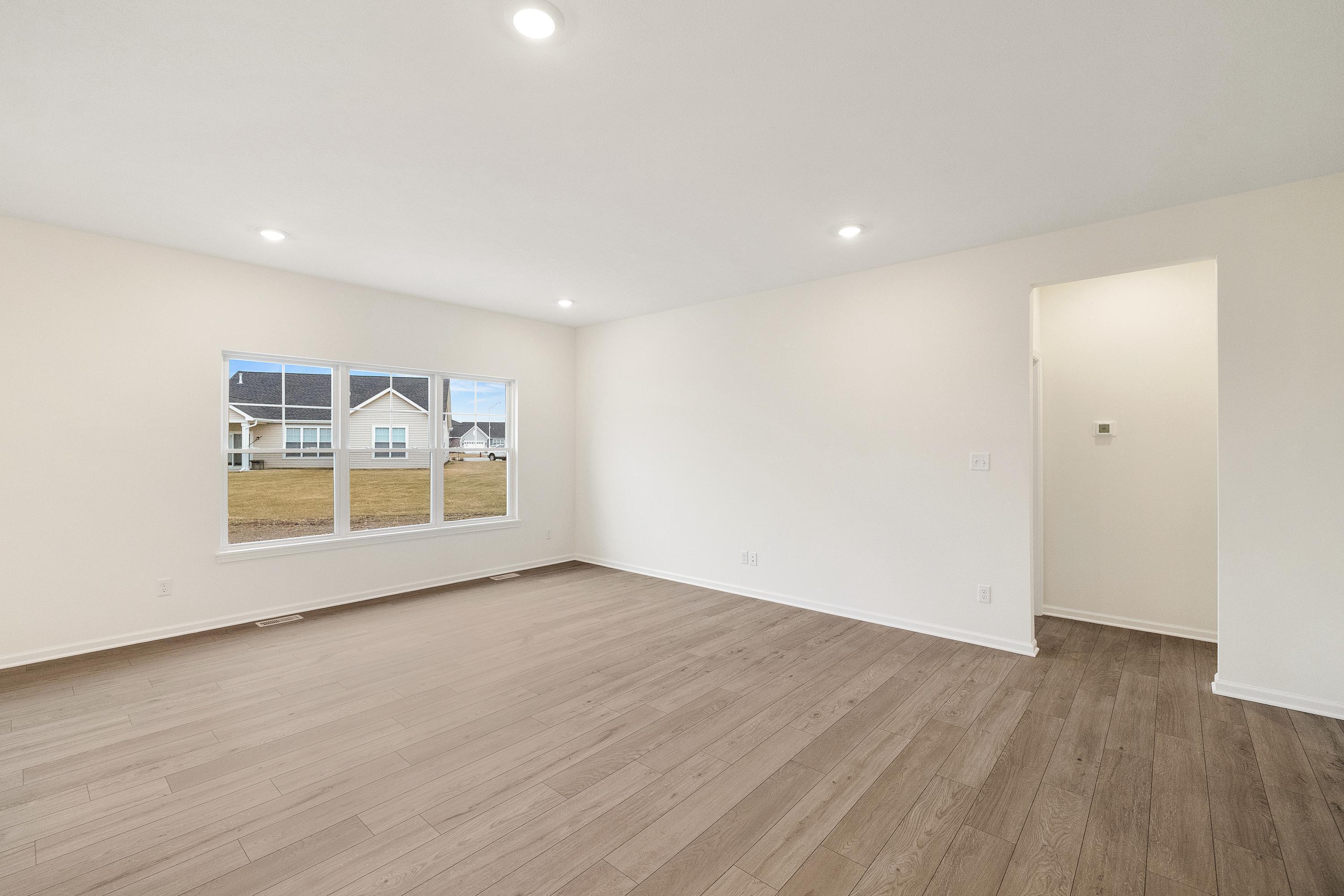 5264 Red Rock Lane Schererville, IN 46375 - Photo 8 of 21 a view of an empty room with wooden floor and a window
