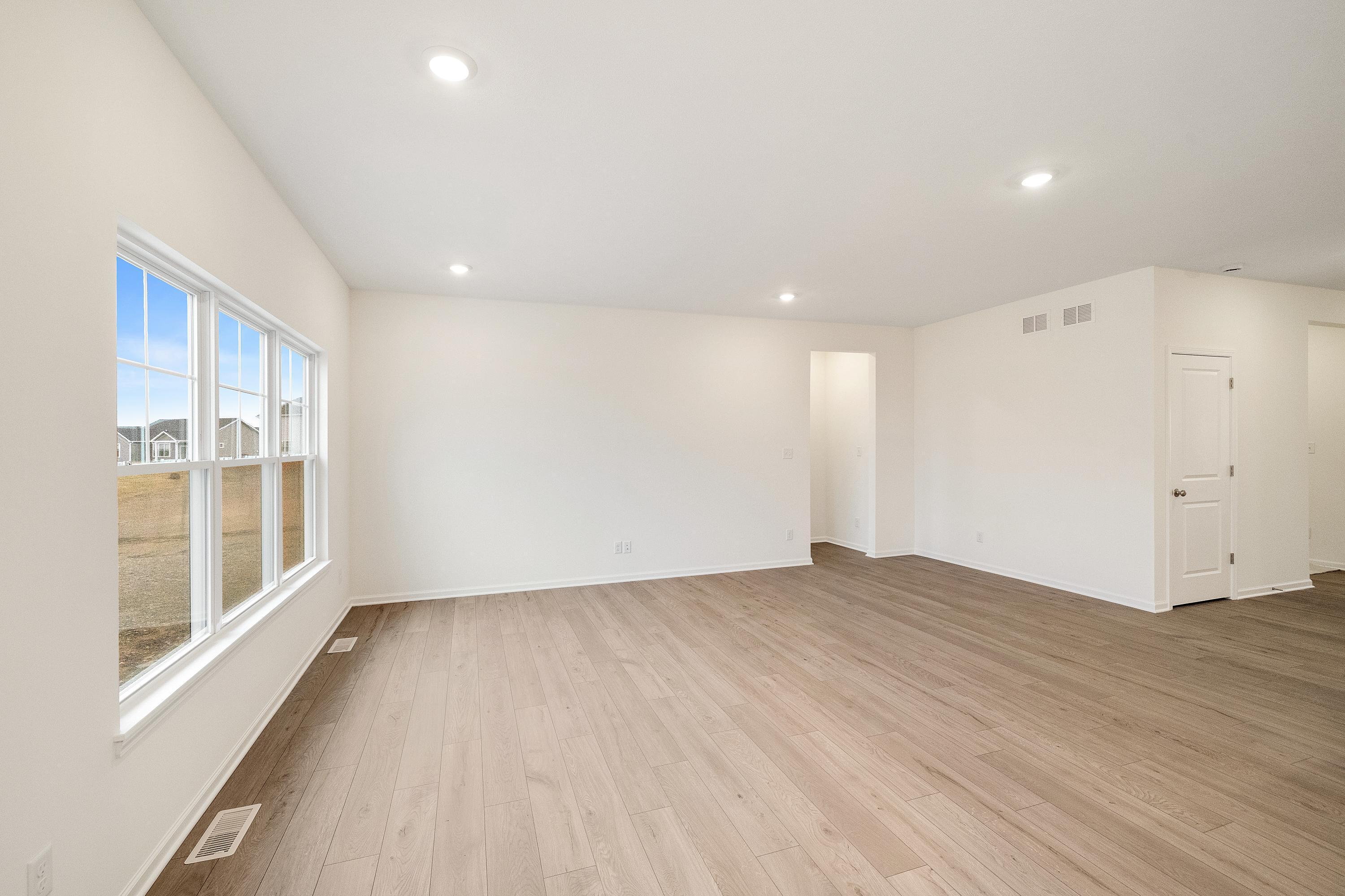5264 Red Rock Lane Schererville, IN 46375 - Photo 9 of 21 an empty room with wooden floor and windows