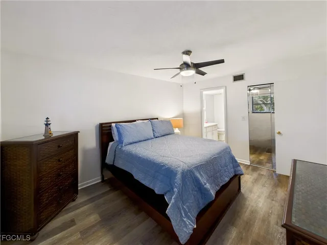 a spacious bedroom with a bed and a chandelier