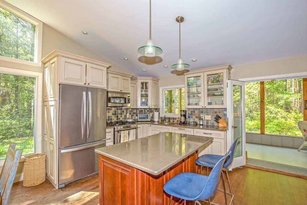 265 Fox Den Road Tolland, MA 01034 - Photo 17 of 37 a kitchen with granite countertop a table chairs stainless steel appliances and windows