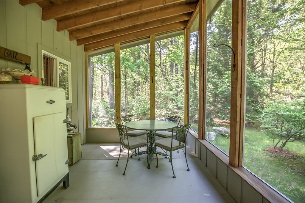 265 Fox Den Road Tolland, MA 01034 - Photo 25 of 37 a dining room with furniture and a floor to ceiling window