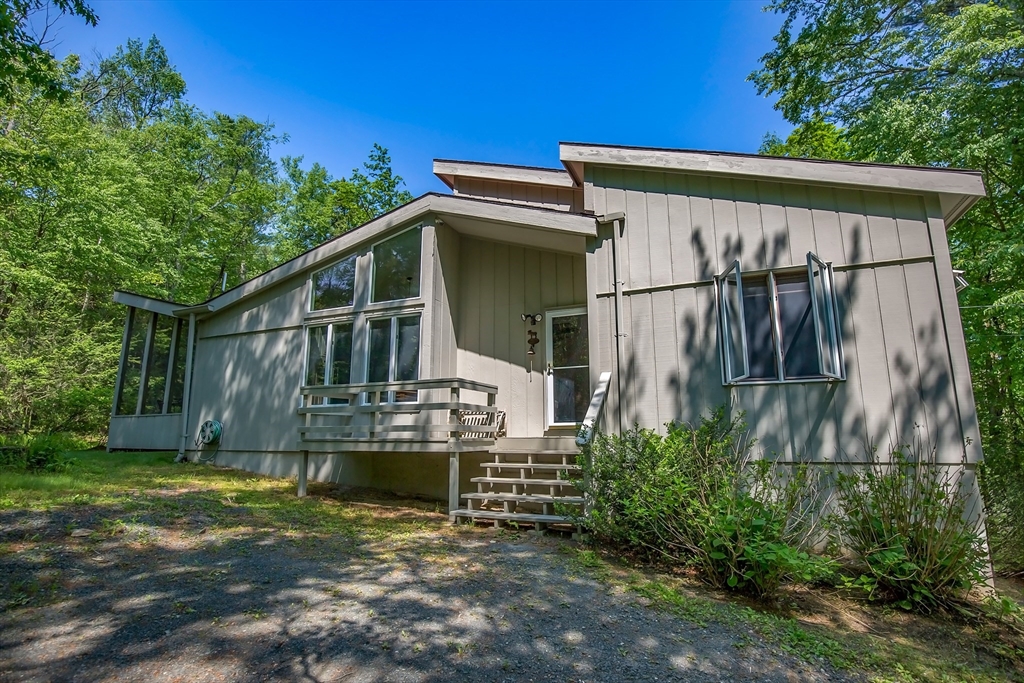 265 Fox Den Road Tolland, MA 01034 - Photo 3 of 37 a view of a house with wooden fence