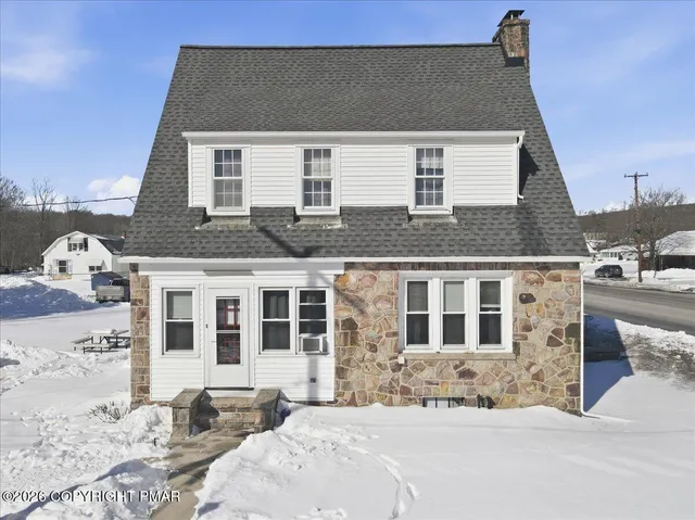 a kitchen with granite countertop cabinets stainless steel appliances a sink and a window