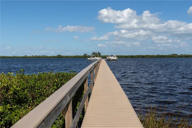 a view of balcony with wooden floor and fence