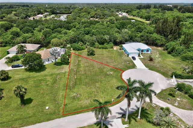 a aerial view of a house with a yard basket ball court and outdoor seating