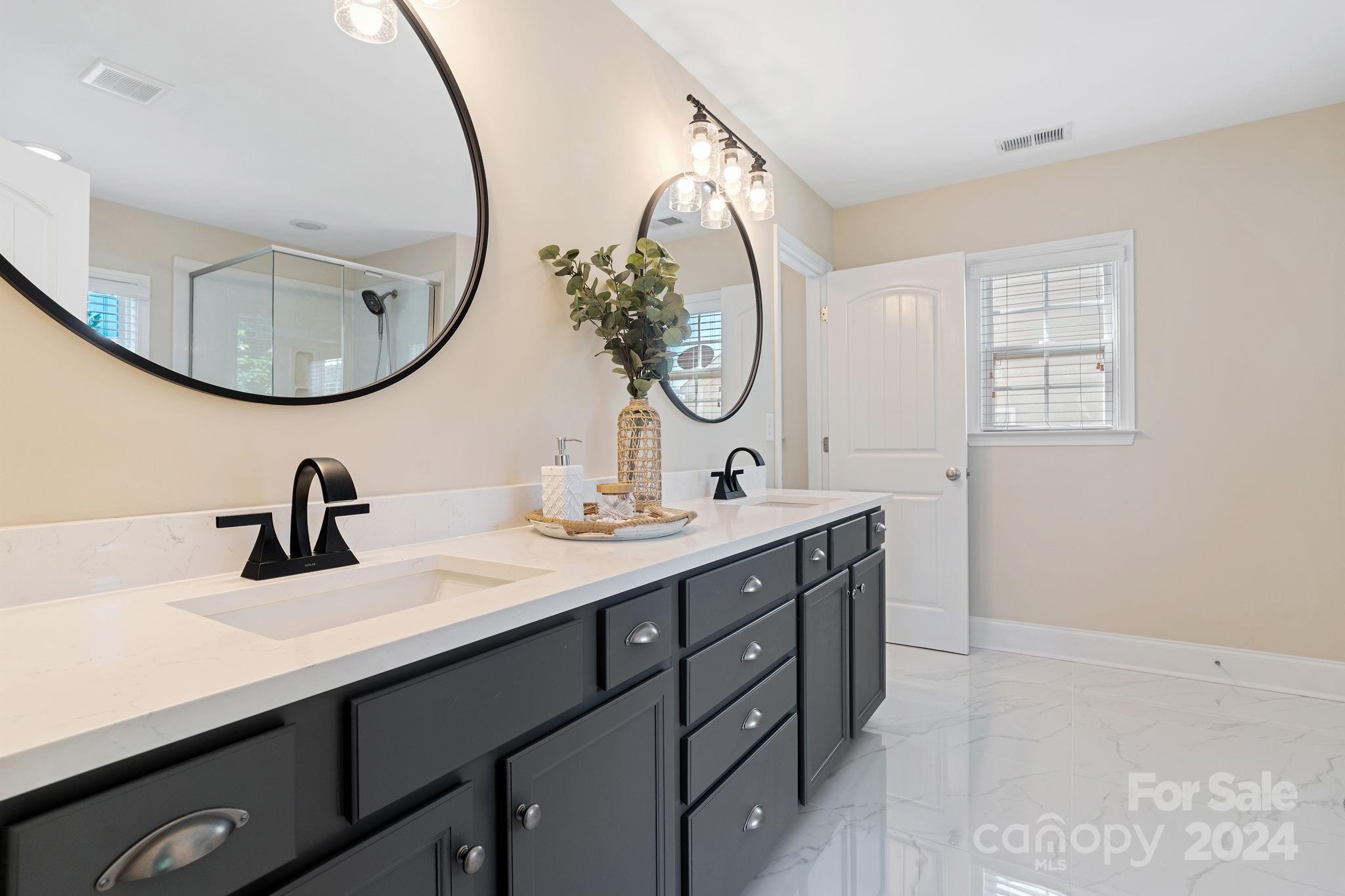 580 Rosemary Lane Fort Mill, SC 29708 - Photo 15 of 37 a bathroom with a double vanity sink and a mirror