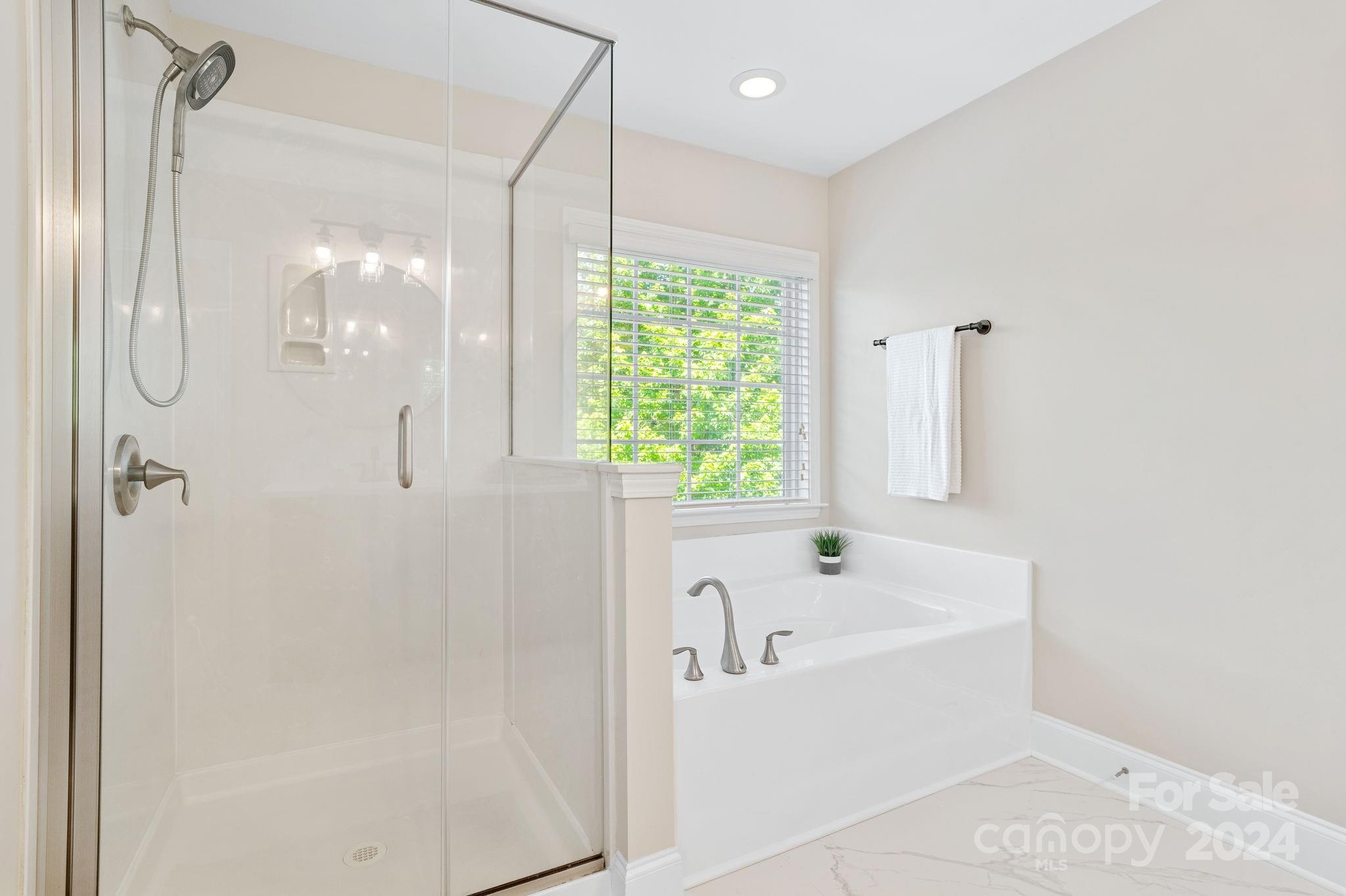 580 Rosemary Lane Fort Mill, SC 29708 - Photo 16 of 37 a white bath tub sitting in a bathroom and shower