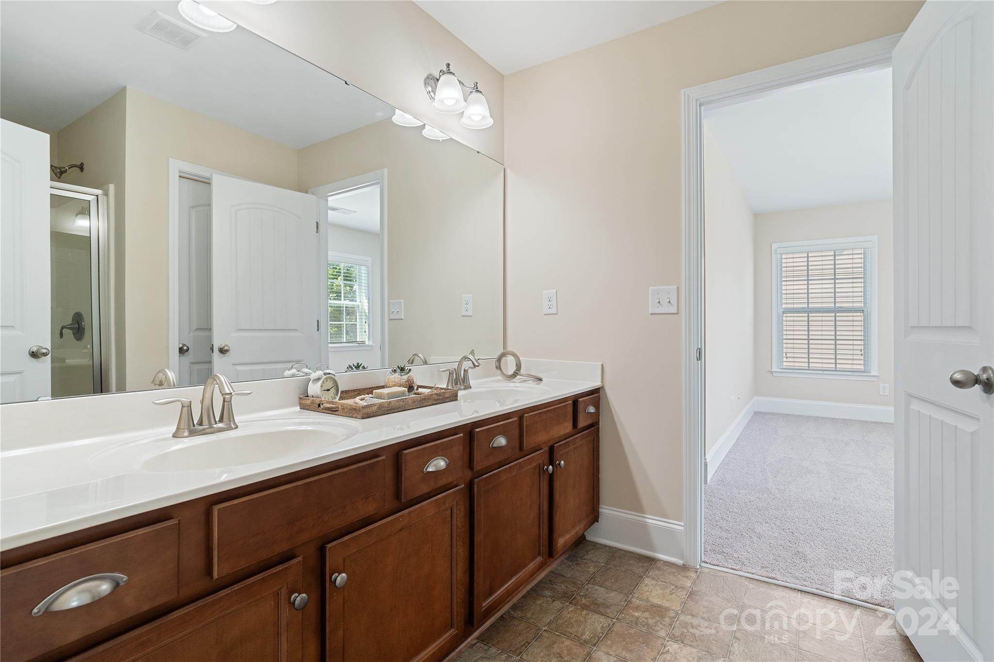 580 Rosemary Lane Fort Mill, SC 29708 - Photo 21 of 37 a bathroom with a double vanity sink and a mirror