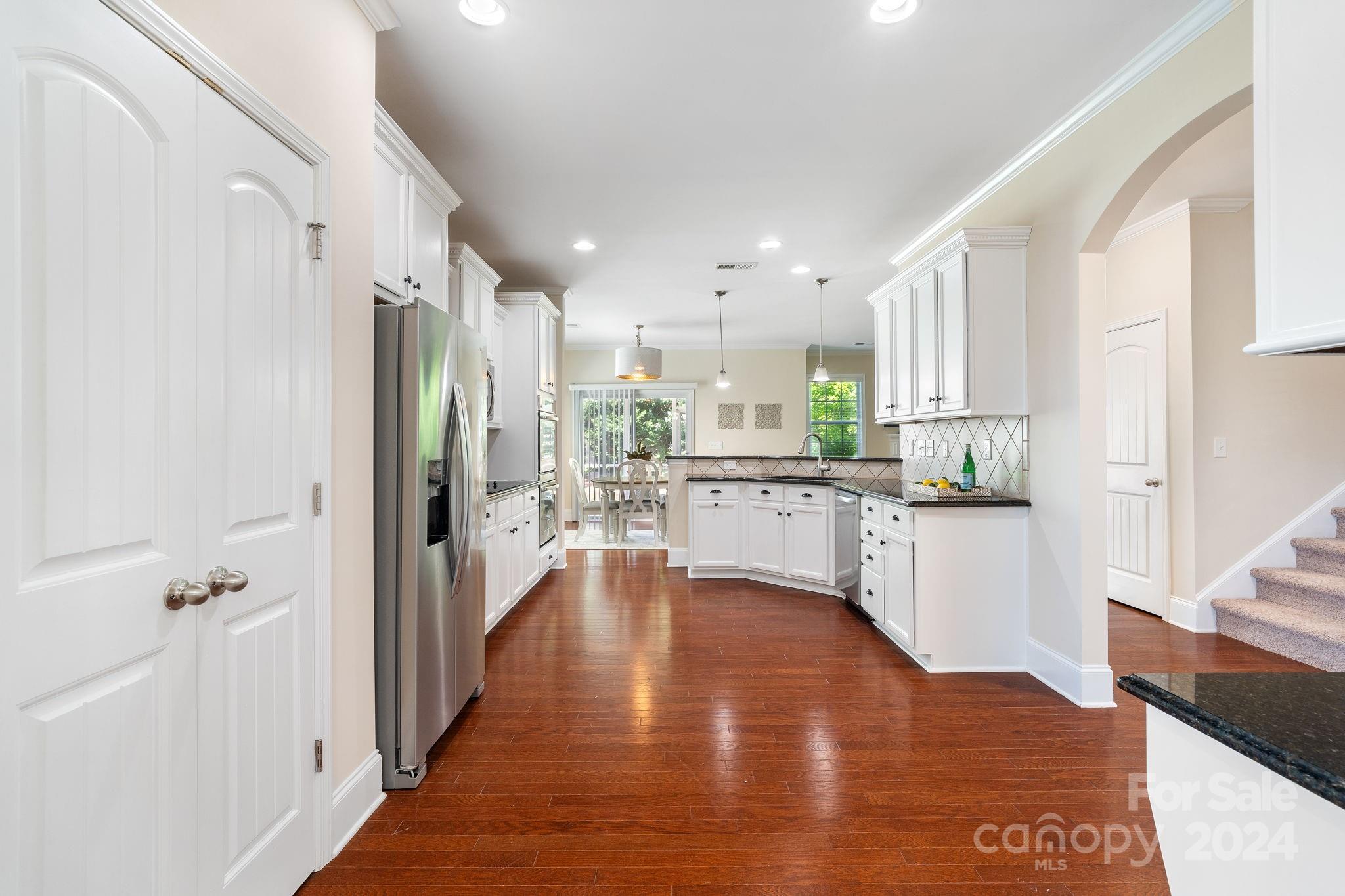 580 Rosemary Lane Fort Mill, SC 29708 - Photo 5 of 37 a kitchen with kitchen island white cabinets and refrigerator